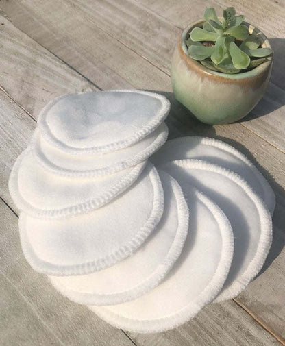 White round reusable facial pads, neatly stacked soft circles.
