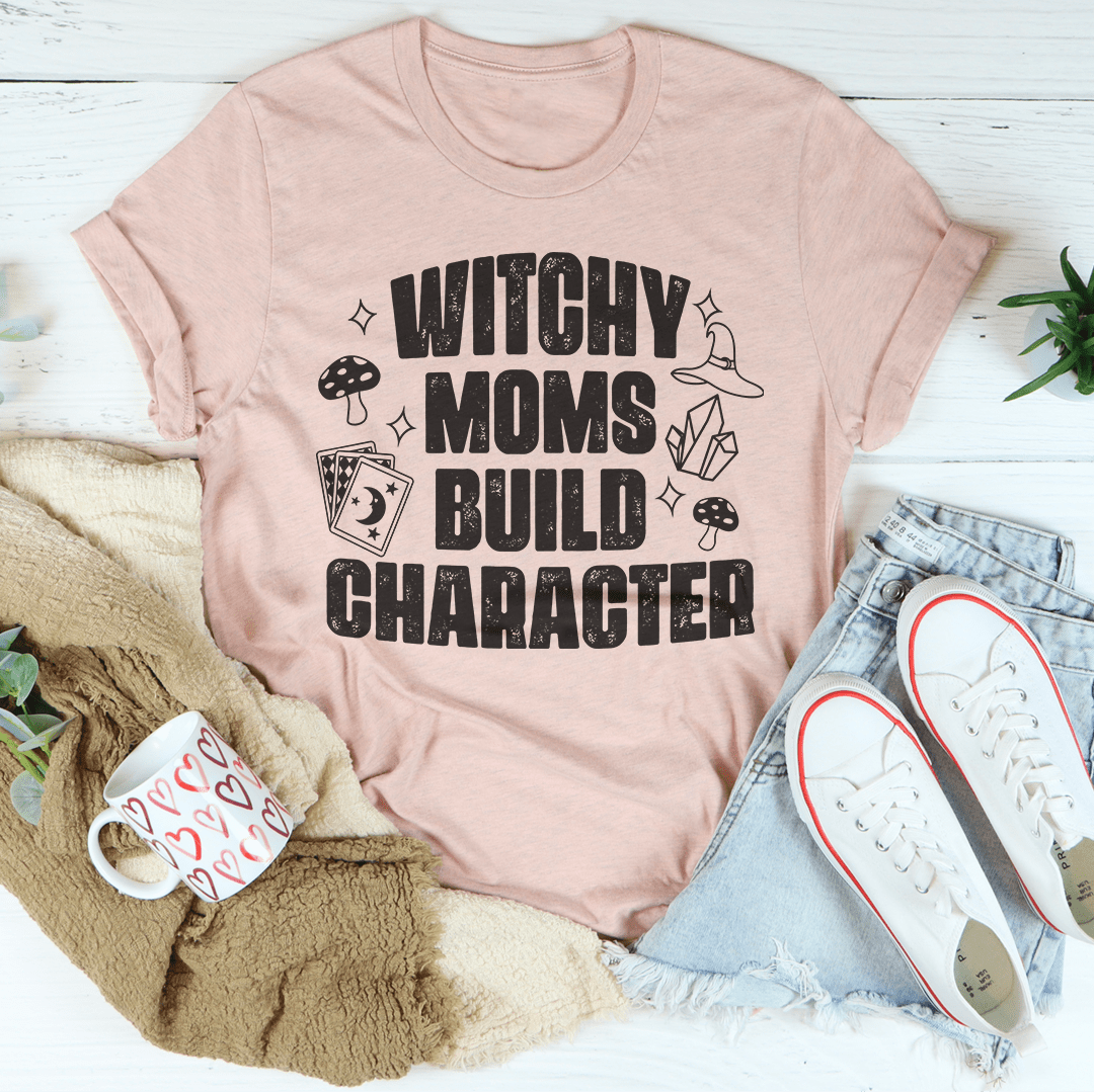 Blush graphic t-shirt with witchy slogan 'WITCHY MOMS BUILD CHARACTER'.
