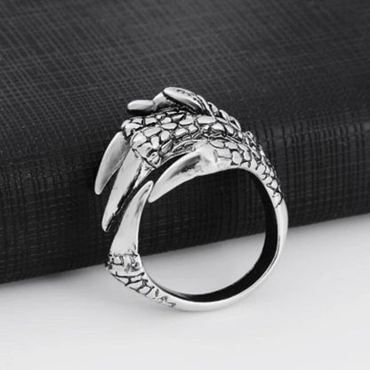 Silver open claw ring with dragon-scale texture and claw tips, curved band