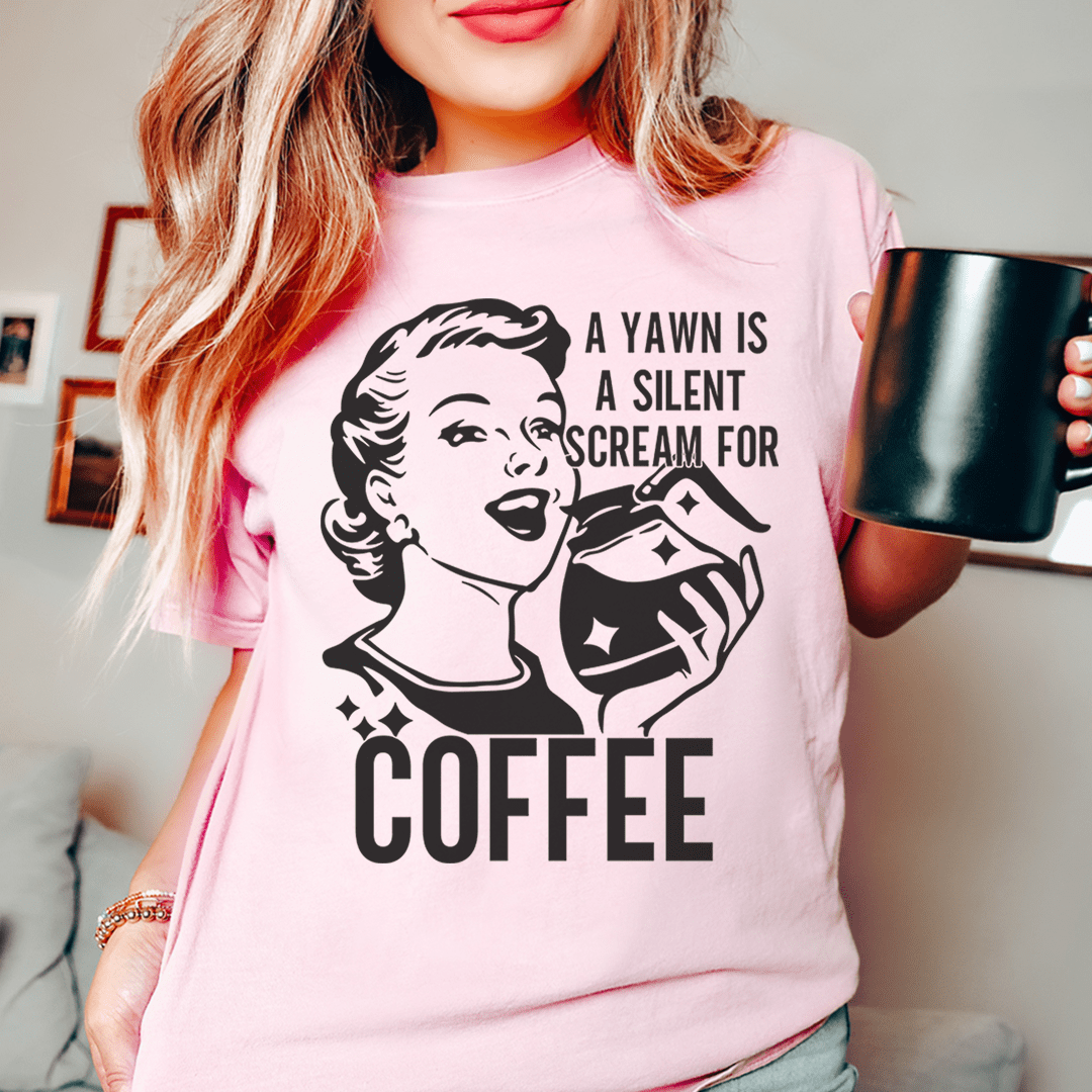 Pink crew-neck t-shirt with bold black coffee-themed graphic on the front