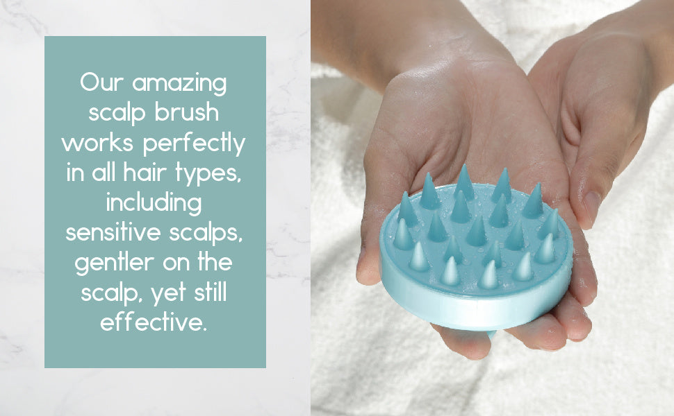 Teal scalp massager brush held in hand, rounded silicone head with spike bristles
