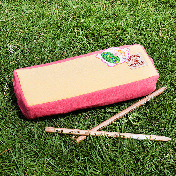 Embroidered pencil pouch, flat back view, pink and beige panel with cute patch emblem