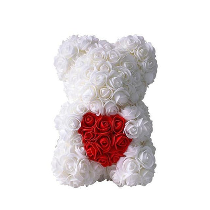 White rose teddy bear with a red heart-shaped rose patch and black ribbon bow