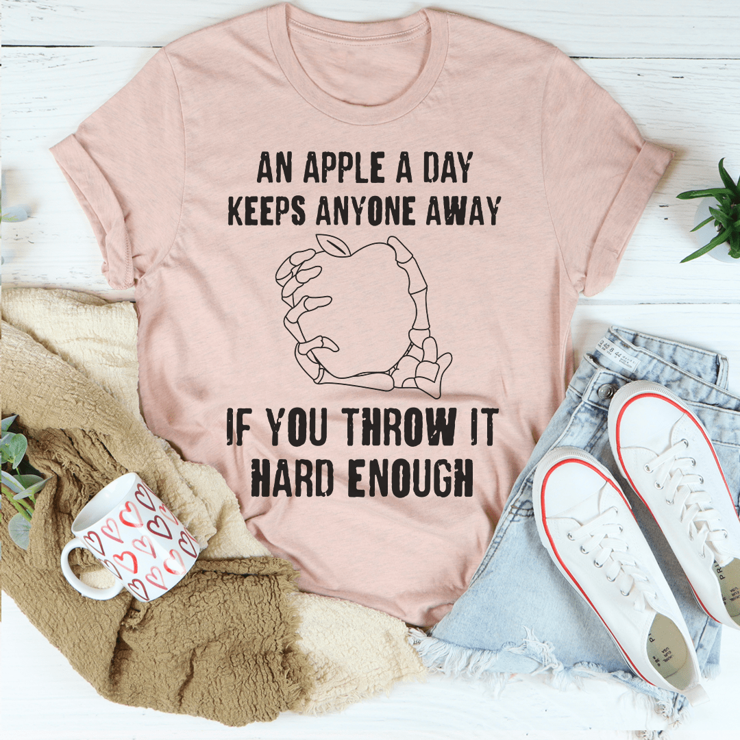 Mauve/pink graphic T-shirt with apple outline and bold slogan text on chest