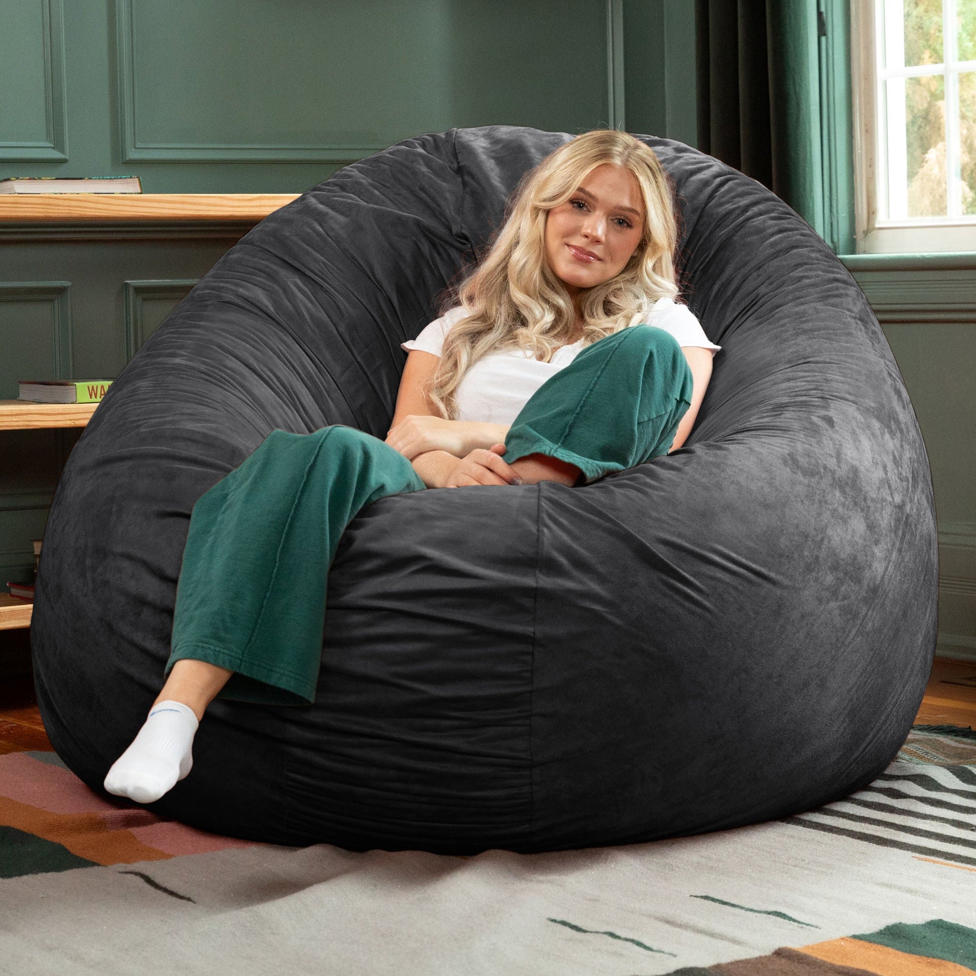 Black cocoon bean bag chair with microsuede upholstery, large rounded shape