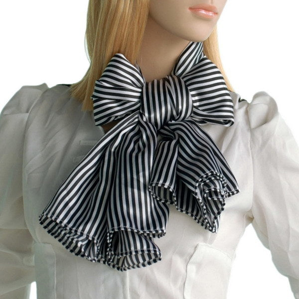Black and white striped scarf tied in a bow with fringed tails