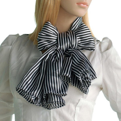 Black and white striped scarf tied in a bow with fringed tails