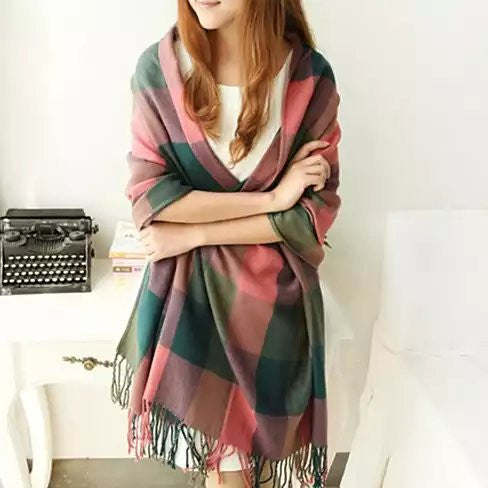 Reversible shawl with multicolor plaid blocks in green, pink, and teal; fringed edges.