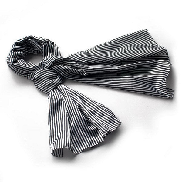 Black and white striped silk scarf wrap with fringed ends, folded and draped