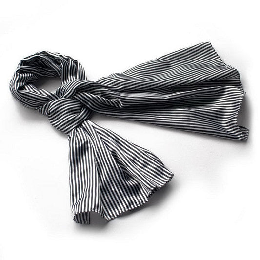 Black and white striped silk scarf wrap with fringed ends, folded and draped
