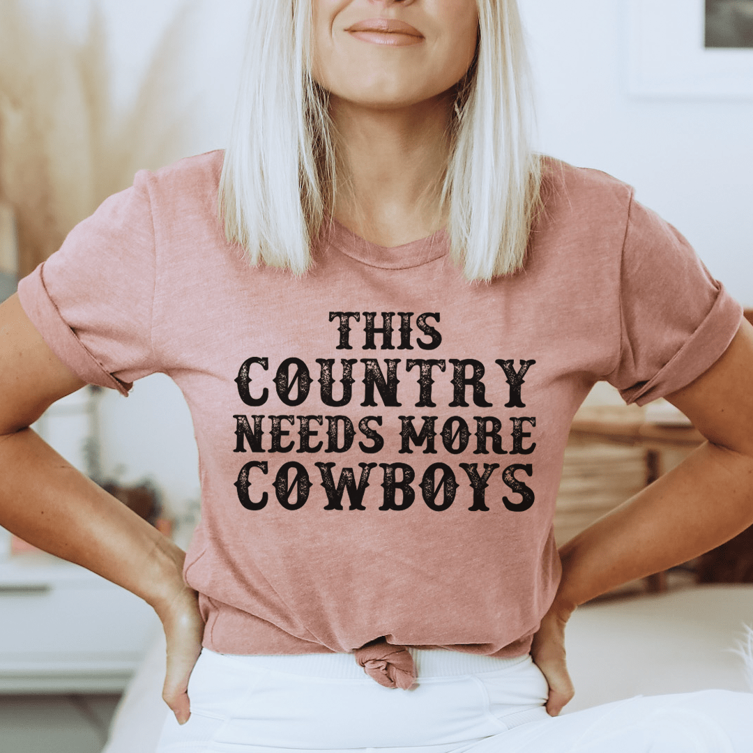 Mauve T-shirt with 'THIS COUNTRY NEEDS MORE COWBOYS' graphic