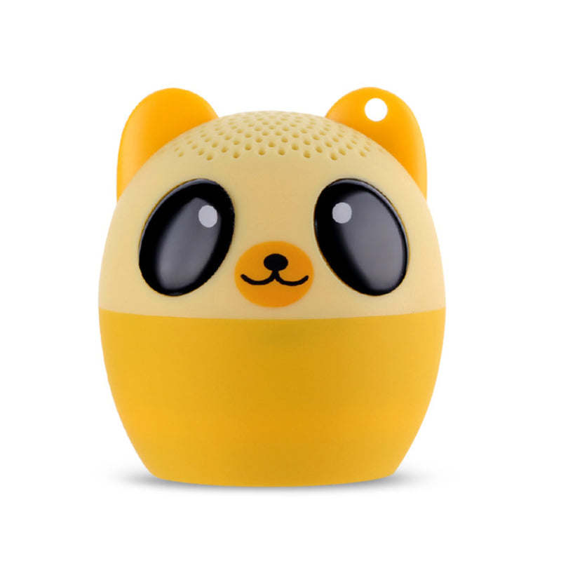 Cream-and-yellow dog-shaped Bluetooth speaker with black ears and wide eyes.