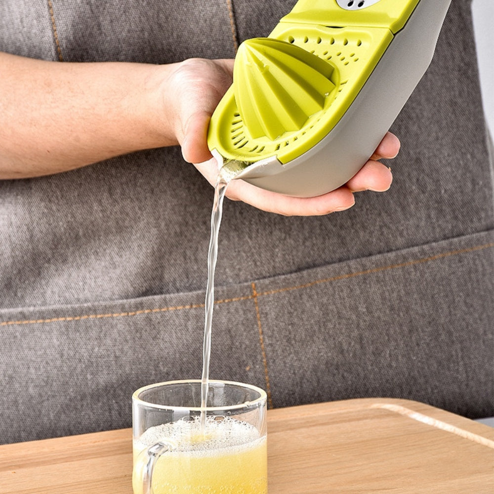 Green citrus juicer held over a glass; juice being poured from the spout