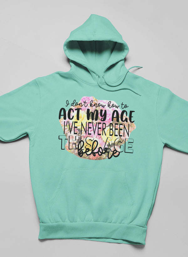 Mint green hoodie with hood and kangaroo pocket, 'Act my age' slogan print