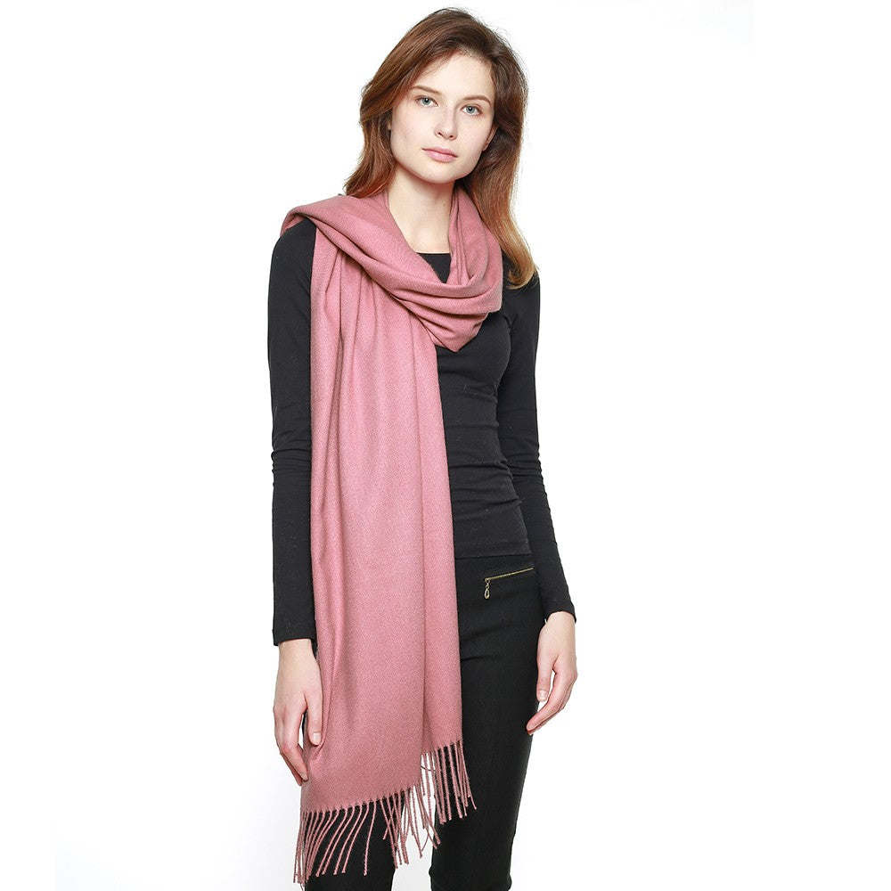 Dusty pink pashmina shawl with long fringe, draped over shoulders