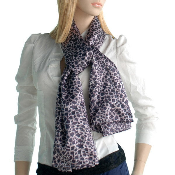 Leopard print silk scarf worn around neck, draped with soft bow