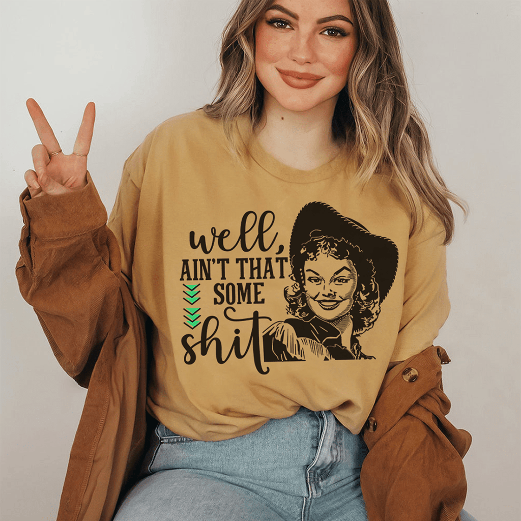 Mustard T-shirt with front portrait graphic and green chevron detail