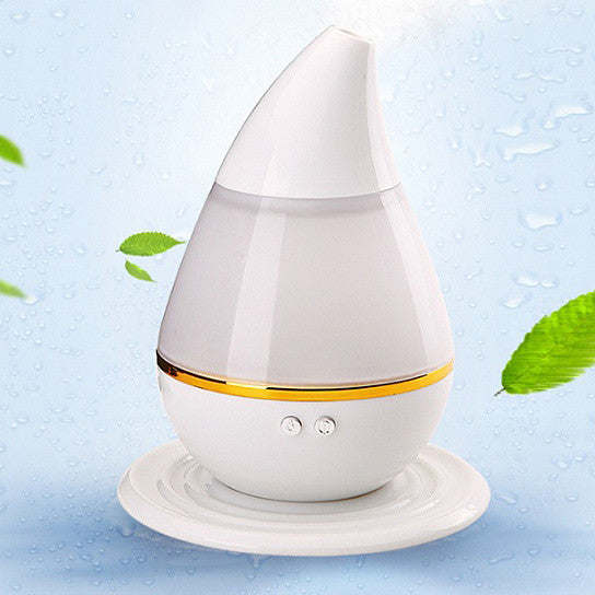 White aromatherapy humidifier diffuser with warm light band on round base