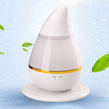 White aromatherapy humidifier diffuser with warm light band on round base