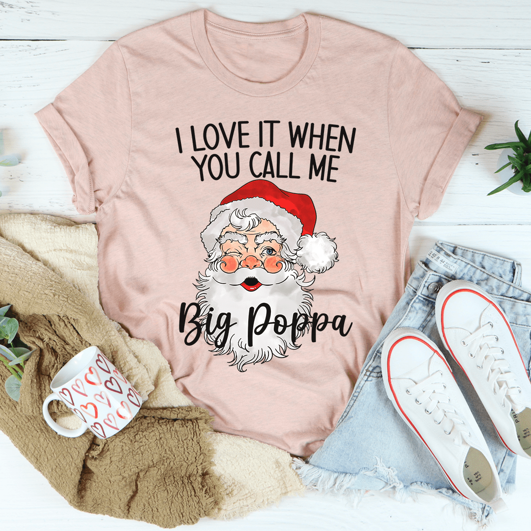 Blush pink T-shirt with slogan text and Santa-style face graphic, crew neck short sleeves