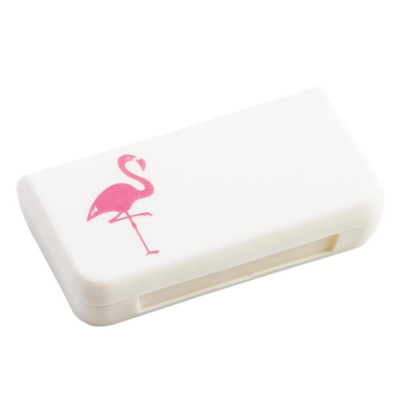 White portable pill organizer case, closed, pink flamingo icon on lid