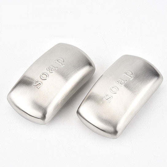 Pair of stainless steel odor remover bars, curved rectangular shapes with embossed text