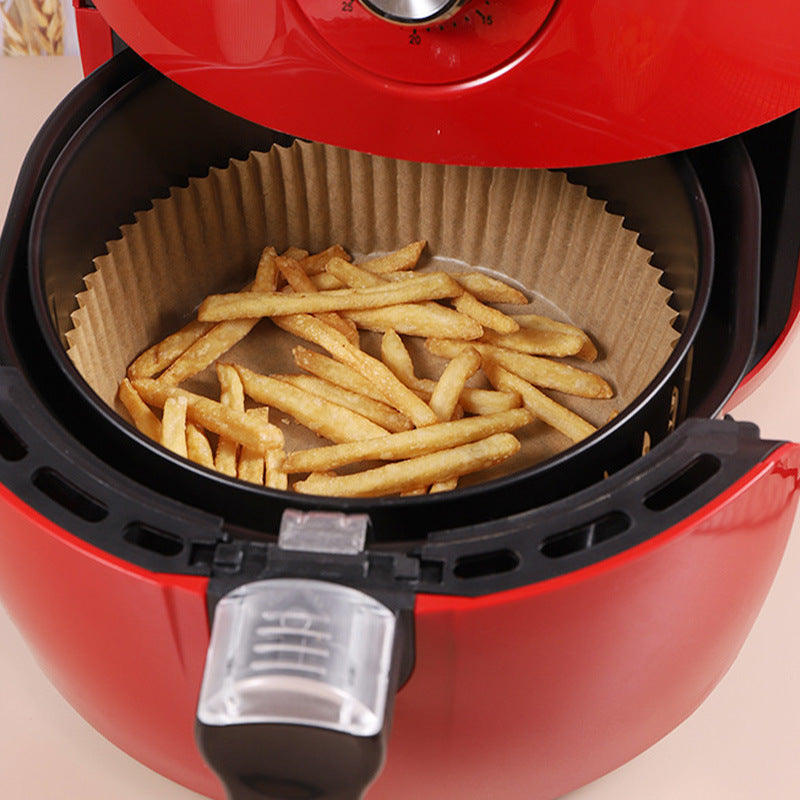 Brown round air fryer paper liner mat with fries inside basket