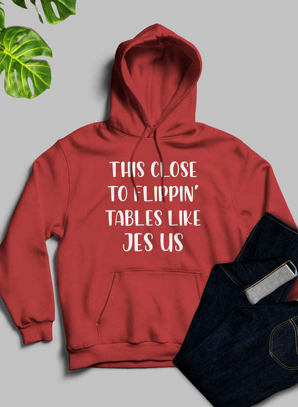 Red hoodie with front hood and kangaroo pocket, centered white statement graphic