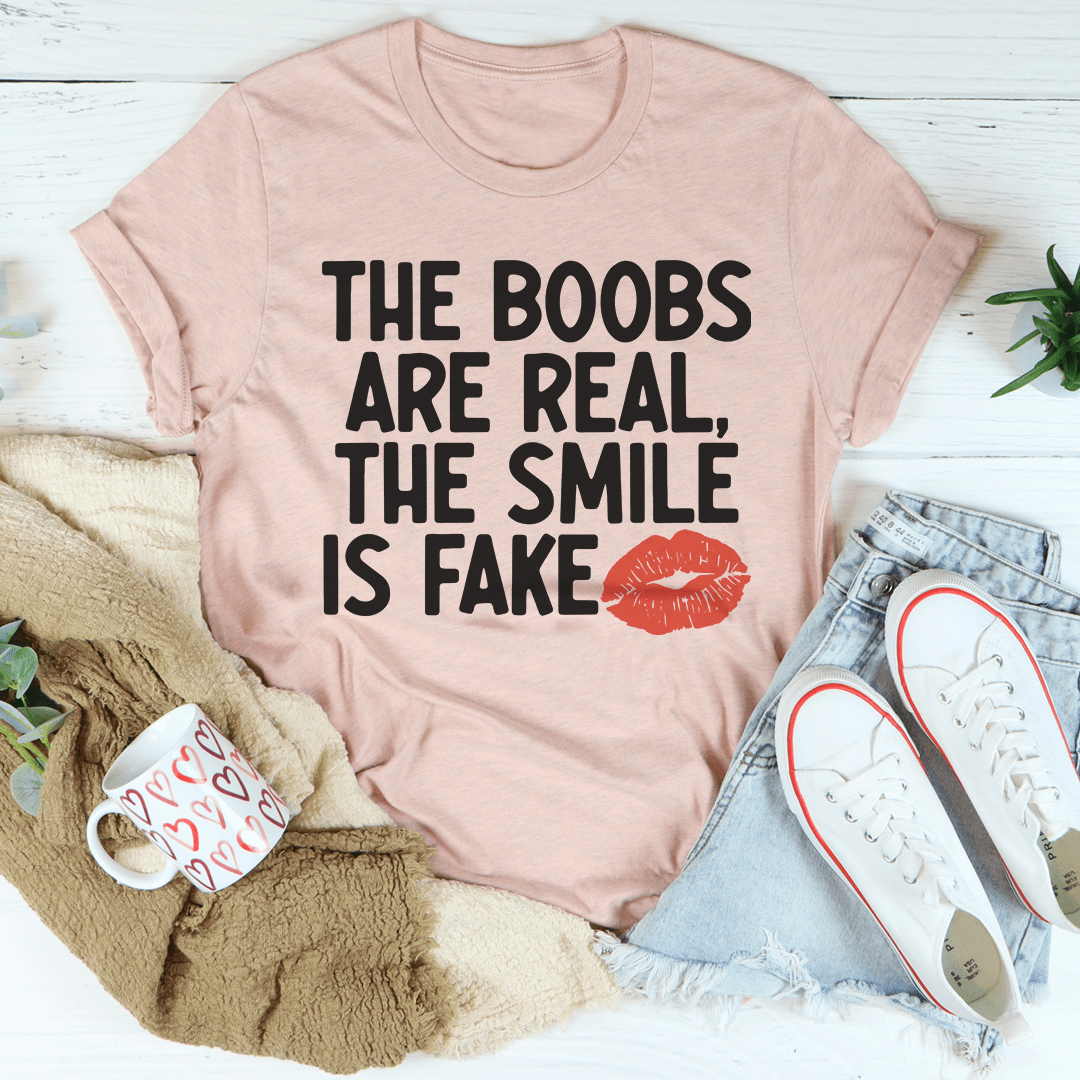 Peach crewneck T-shirt with bold black slogan text and red lips graphic