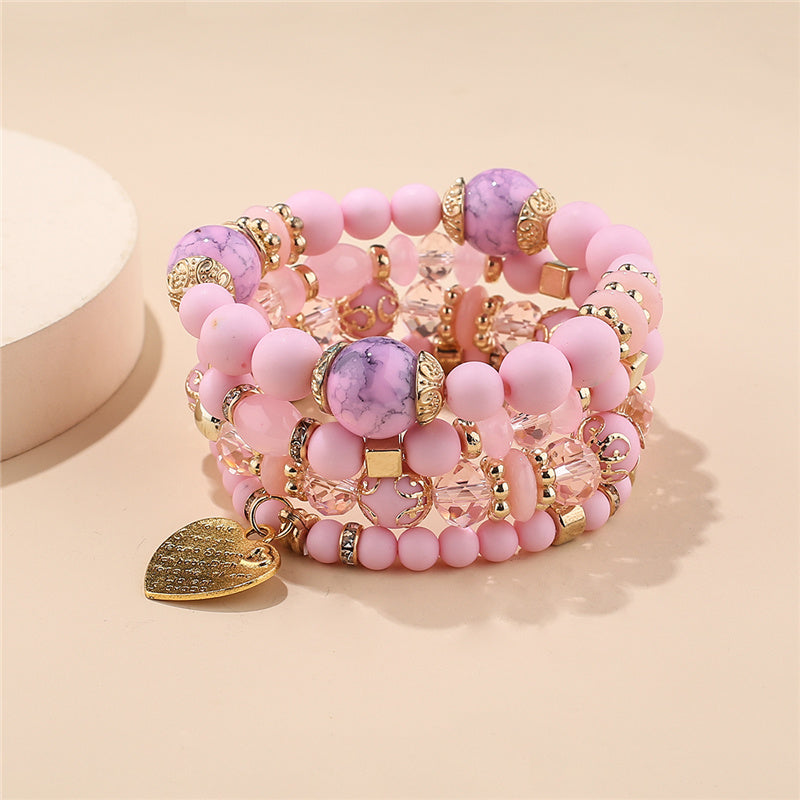 Pink and purple bead layered bracelet set with gold heart charms and stone beads