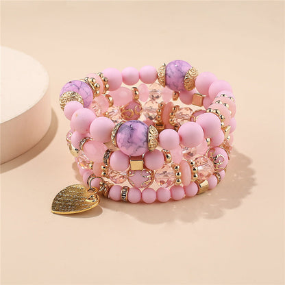 Pink and purple bead layered bracelet set with gold heart charms and stone beads