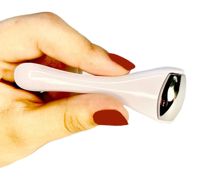 Ice roller massager with white handle and silver end, held by fingers