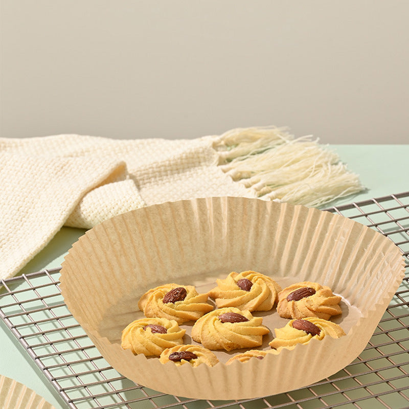 Round beige paper liner mat with baked snacks inside, air fryer liner for non-stick cooking