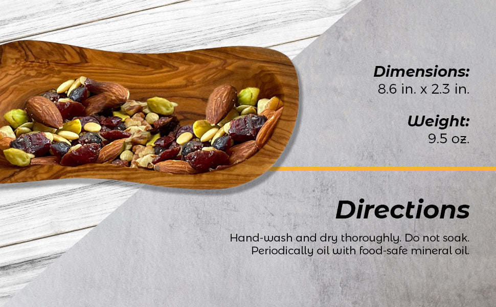 Olive wood serving bowl with mixed olives and nuts, elongated canoe shape.