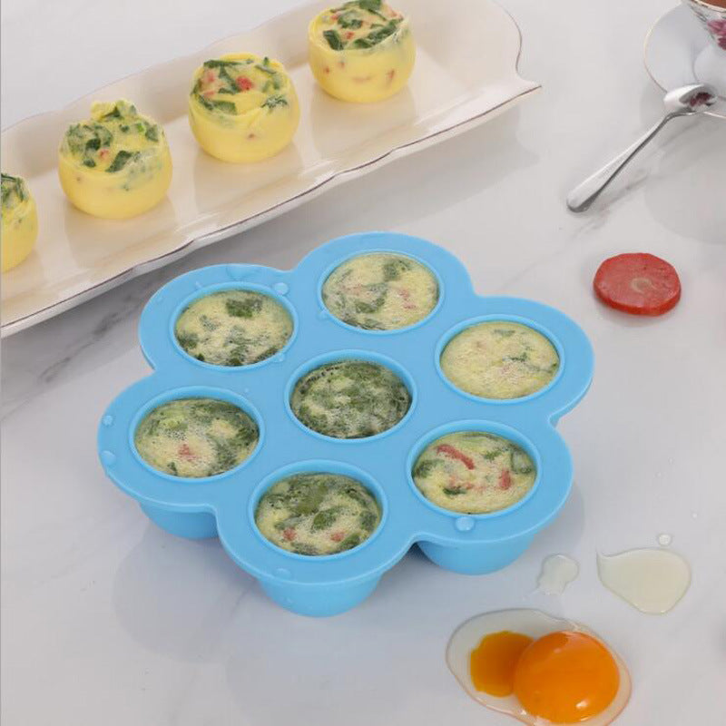 Blue silicone 7-cavity egg bite mold holding baked egg bites
