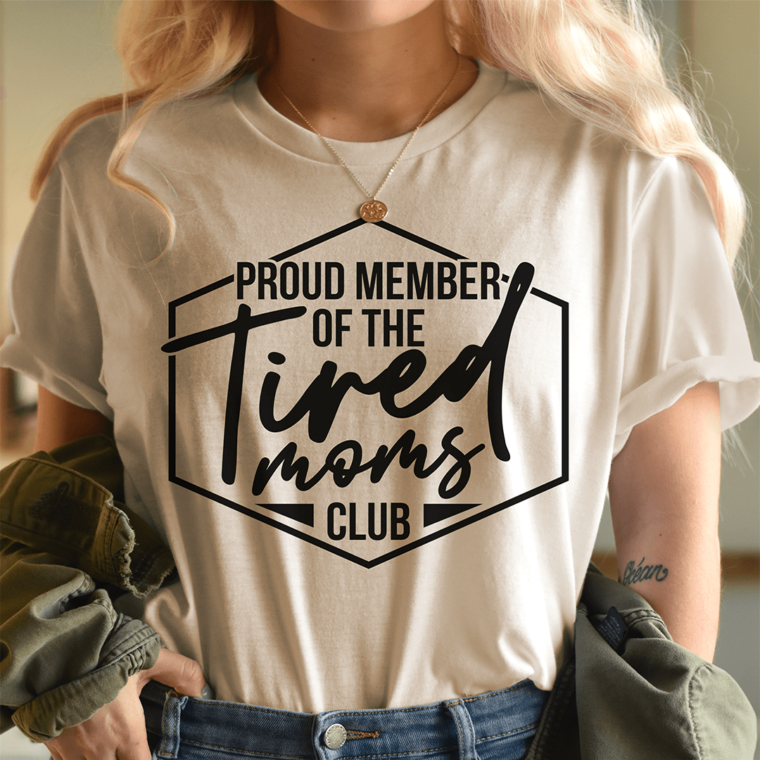 Beige crewneck T-shirt with 'Proud Member of the Tired Moms Club' front graphic
