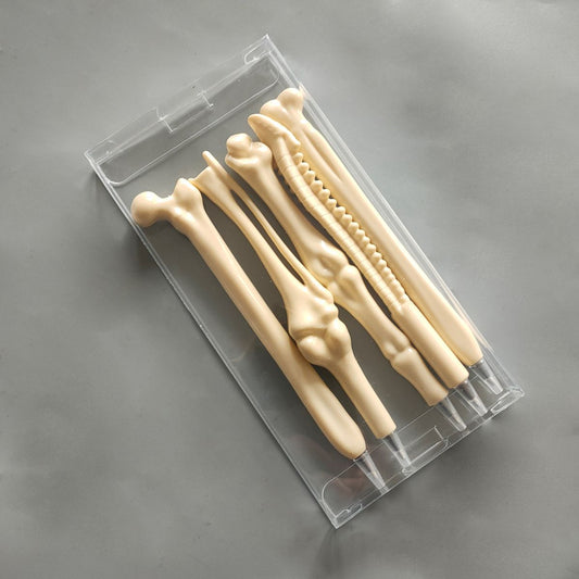 Bone-shaped ballpoint pen set in beige with clear plastic case