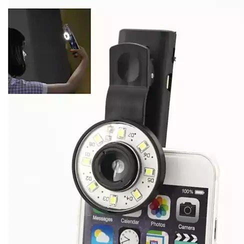 Clip-on selfie LED light with 4x wide-angle lens, black holder attached to smartphone