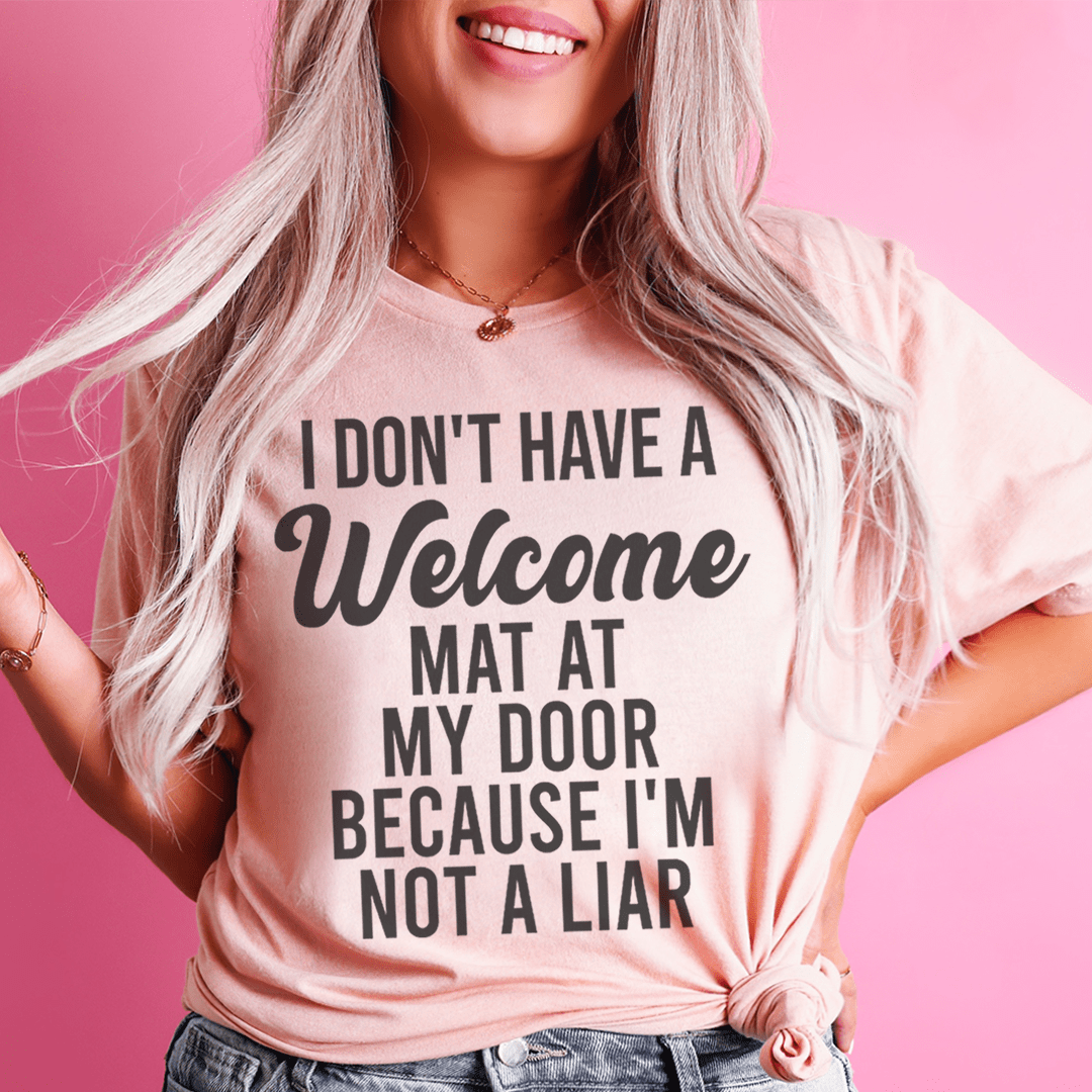 Light pink crew-neck T-shirt worn, Welcome Mat quote graphic
