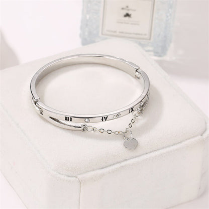 Silver-tone bangle bracelet with roman numerals and heart pendant on a chain