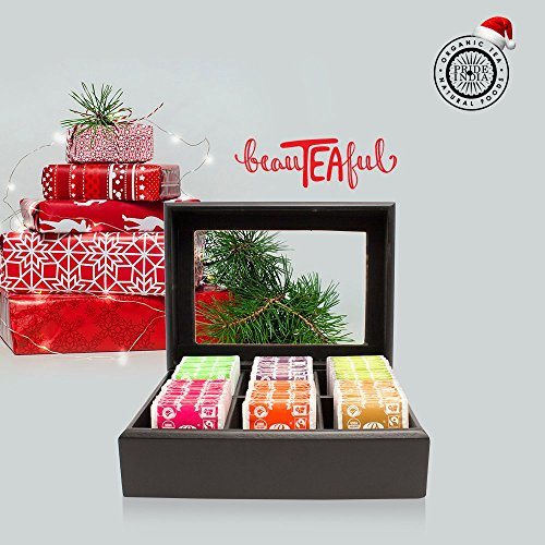 Open black tea bag chest with colorful tea sachet boxes in a tri-section tray.