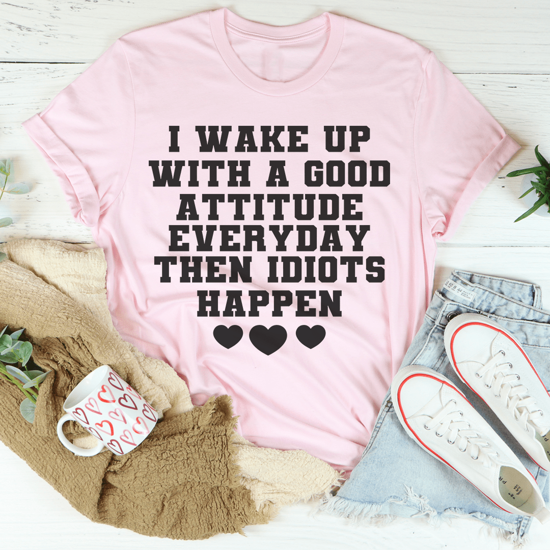 Pink crewneck T-shirt with black attitude slogan and heart icons.