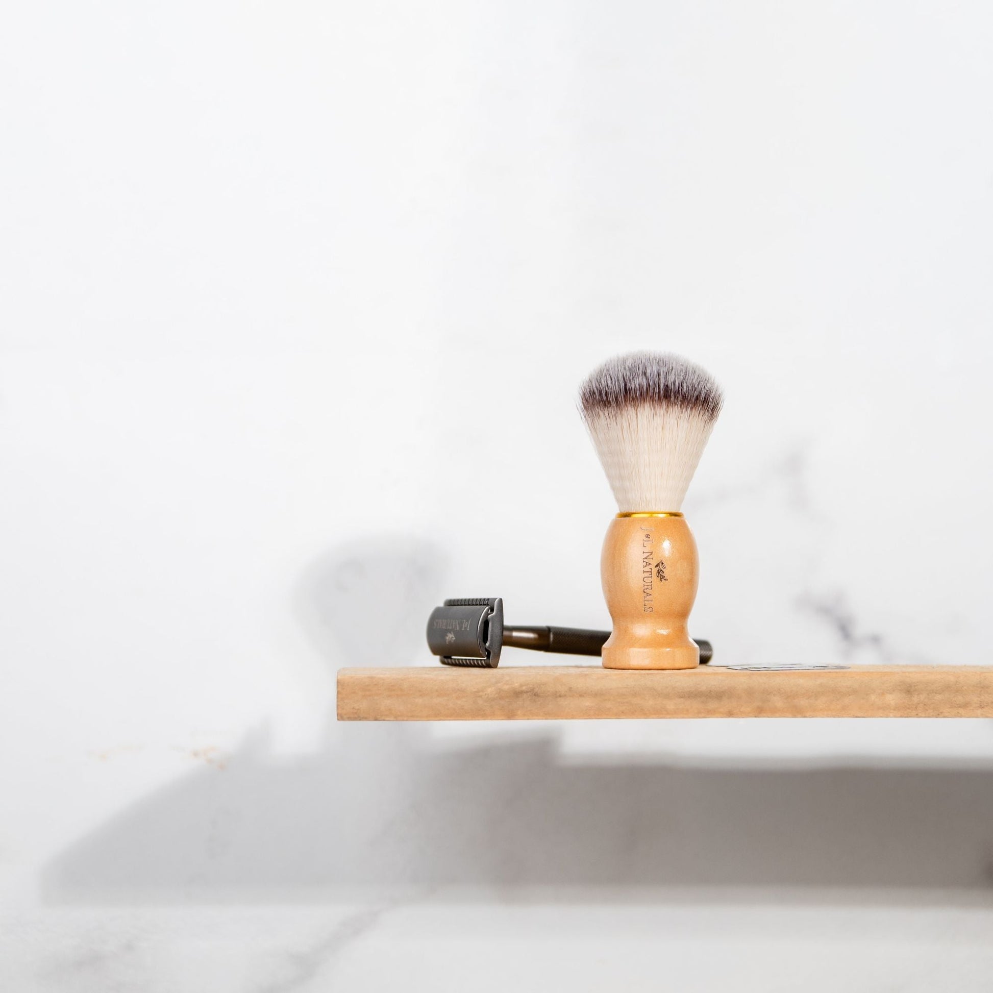 Shave brush with short tapered bristles and light wood handle