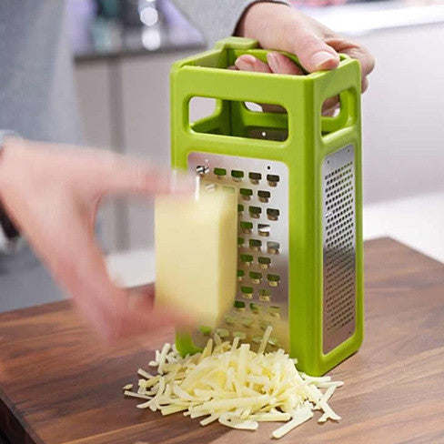 Green foldable slicer and grater held in hand, grating side visible