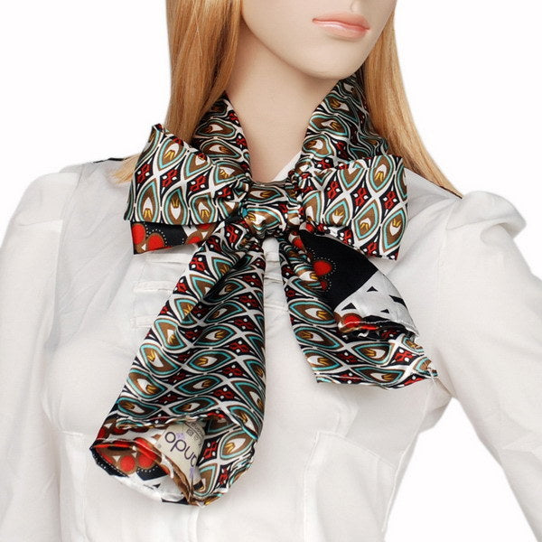 Patterned scarf with tied ends around neck; brown, black, red and teal medallion motif