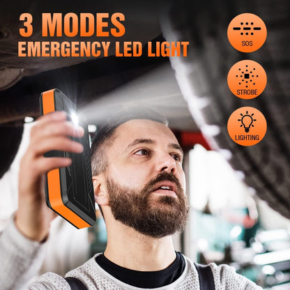 Handheld jump starter with flashing LED light held near a person