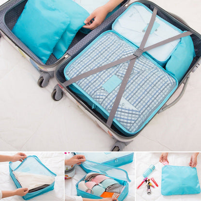 Turquoise packing cubes with straps and zipper tops arranged inside a suitcase