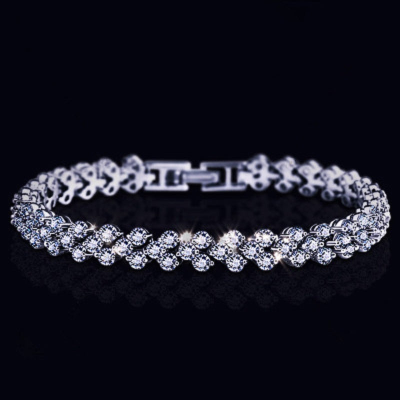 Silver tennis bracelet with round stones, hinged clasp, and link details