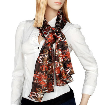 Paisley silk scarf worn at neck, dark brown with red and cream pattern
