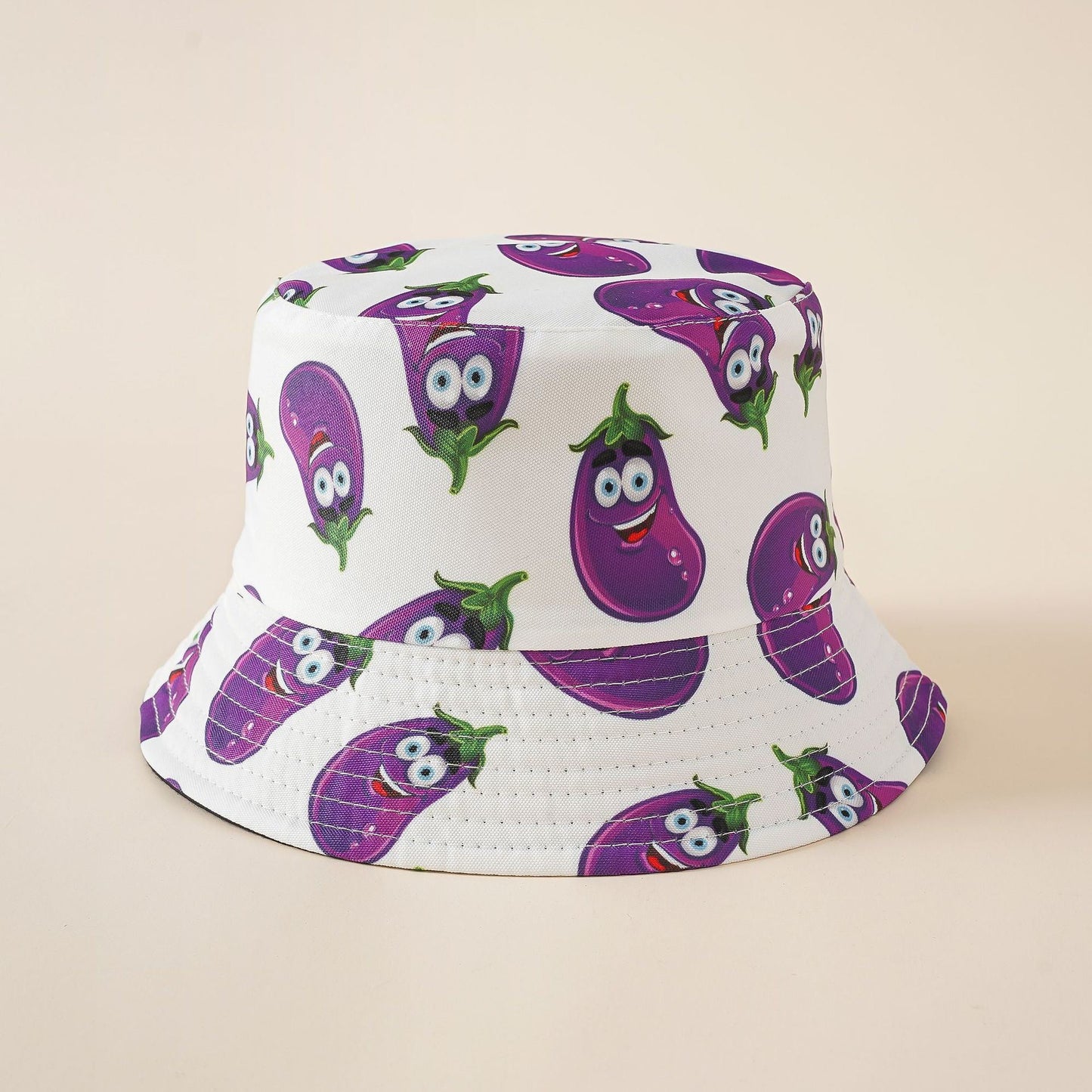 Fisherman hat in white with purple cartoon eggplant pattern, wide brim